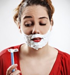 Woman contemplating shaving her face image